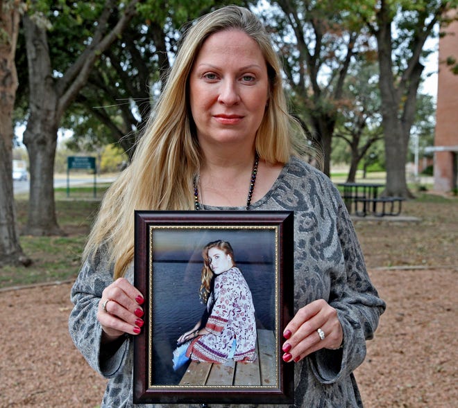 Christine Edmondson poses for a photo with a portrait of her daughter, Drew Crenshaw, in this Wednesday, Nov. 27, 2019 photo.