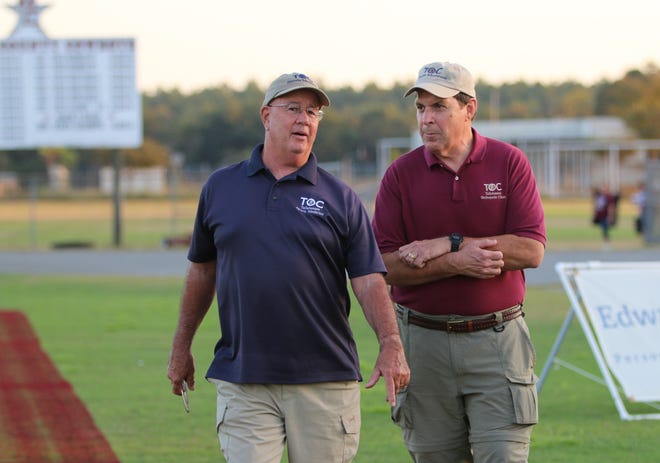 Tallahassee Orthopedic Clinic certified athletic trainer Jim Watson (left) and orthopedic surgeon Dr. Floyd Jaggears hang out before a game at Madison County's Boot Hill Stadium.