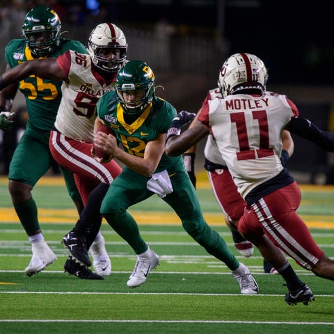 Baylor quarterback Charlie Brewer tries to avoid t