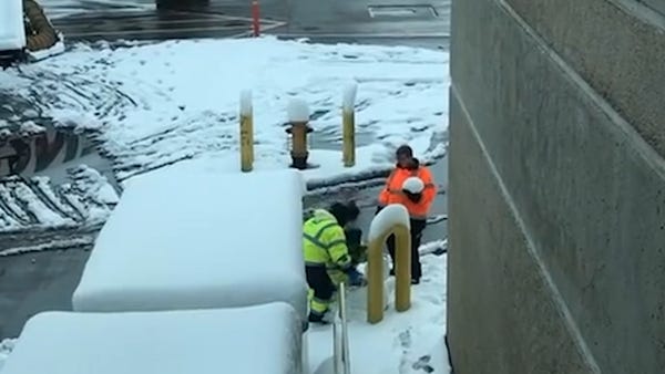 Denver airport workers spotted building snowman