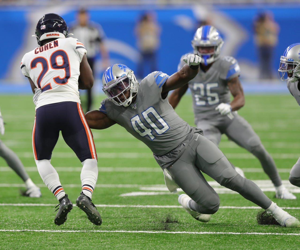 Detroit Lions linebacker Jarrad Davis tackles Chicago Bears running back Tarik Cohen during the first half Thursday, Nov. 28, 2019 at Ford Field.