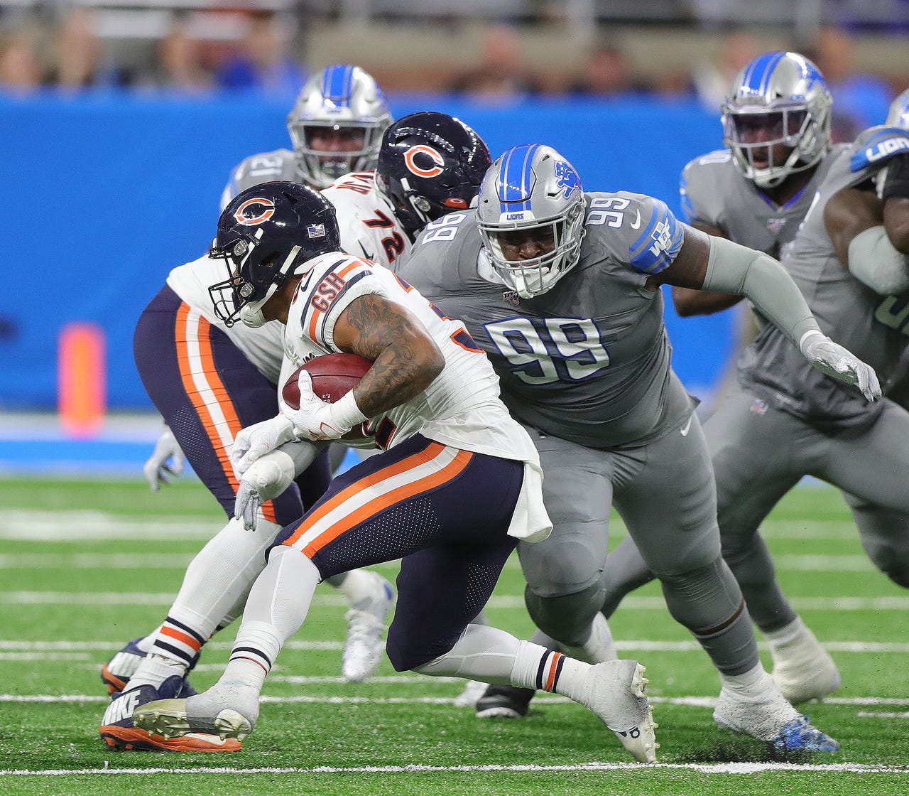 Detroit Lions defensive tackle John Atkins (99) tackles Chicago Bears running back David Montgomery during the first half Thursday, Nov. 28, 2019 at Ford Field.