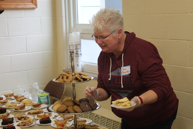 Trinity United Methodist Reverend Anette Dimond picks out desert during the 28th annual United Thanksgiving meal for hungry locals.