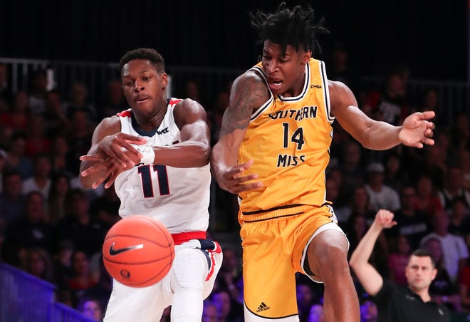 Nov 27, 2019; Nassau, BHS; Gonzaga Bulldogs guard Joel Ayayi (11) and Southern Miss Golden Eagles forward Tyler Stevenson (14) go for the ball during the first half at Imperial Arena. Mandatory Credit: Kevin Jairaj-USA TODAY Sports