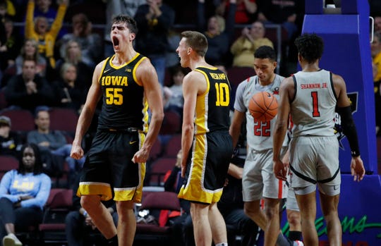Latest Sports News: Iowa's Luka Garza (55) reacts after scoring against Texas Tech during the first half of an NCAA college basketball game Thursday in Las Vegas.