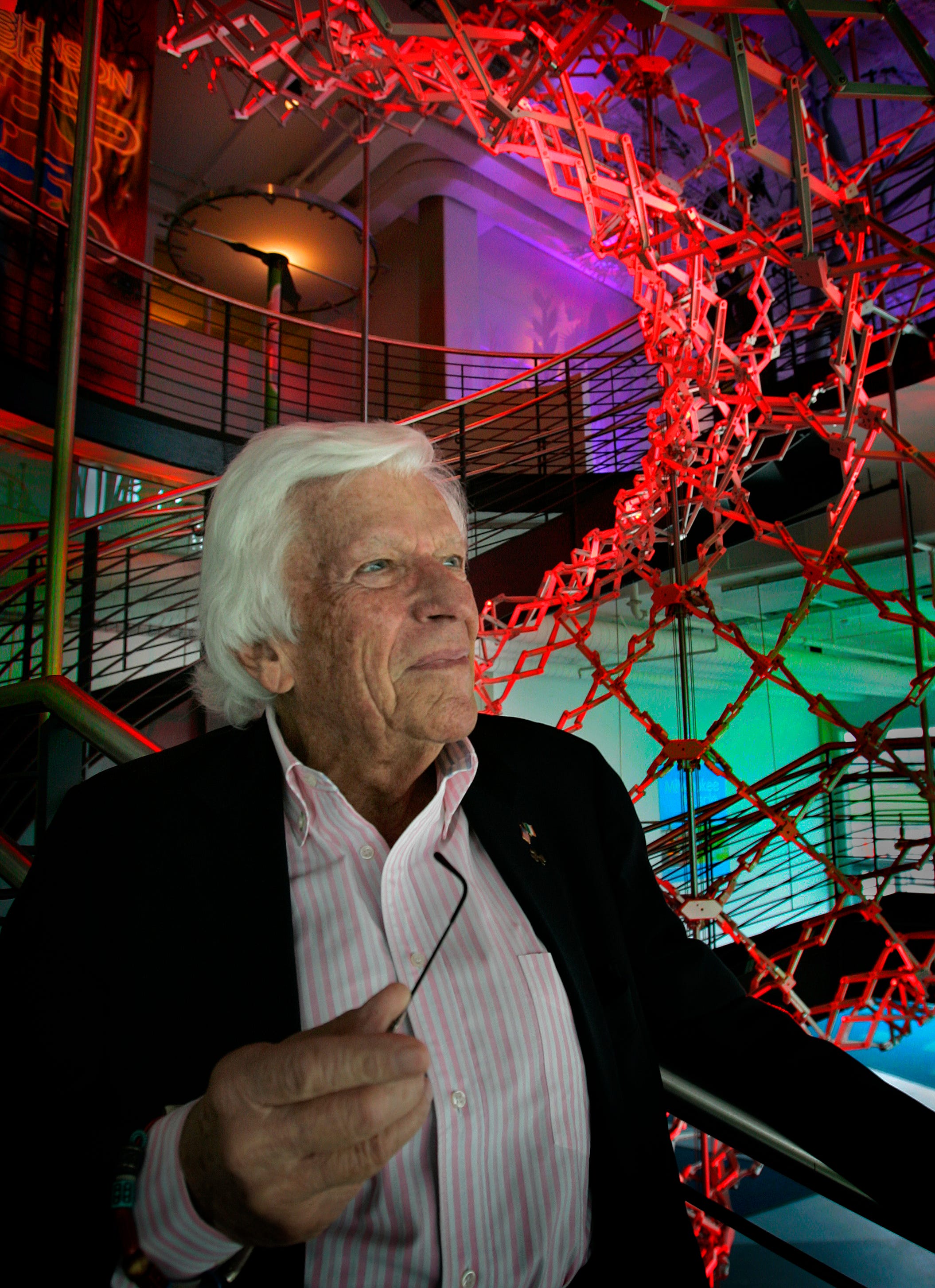 Milwaukee businessman and philanthropist Michael J. Cudahy in a 2007 photo. Behind him rises the Hoberman Genome Sculpture and Double Helix Staircase at Discovery World at Wisconsin Pier, a project he was instrumental in developing.