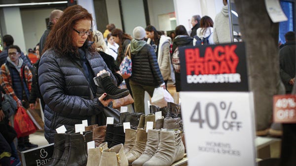 A customer looks for Black Friday deals on boots a