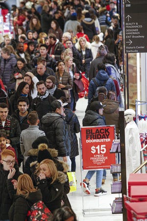 Shoppers at Macy's on Thanksgiving day in New York. Strong holiday sales helped boost consumer spending late last year.