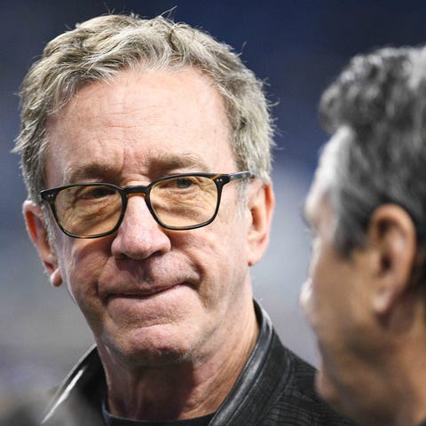 Tim Allen stands on the sidelines before the game 