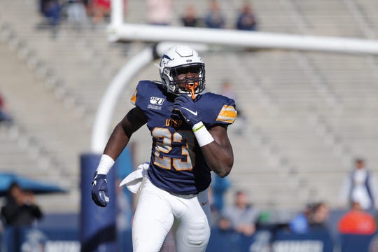 Praise Amaewhule runs off the field after recovering a fumble for a touchdown Saturday against Rice at the Sun Bowl