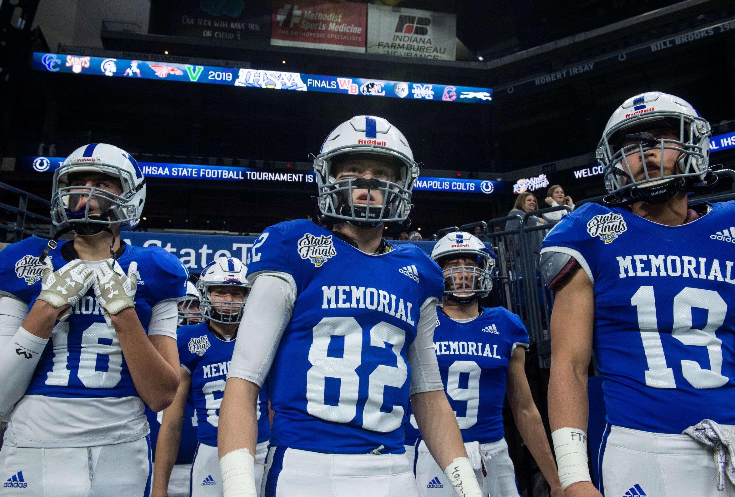 Memorial walks onto the field before the Evansville Memorial vs East Noble IHSAA Class 4A State Championship game at Lucas Oil Stadium in Indianapolis, Ind., Saturday, Nov. 30, 2019. Memorial won the state title in a 21-3 victory over East Noble.