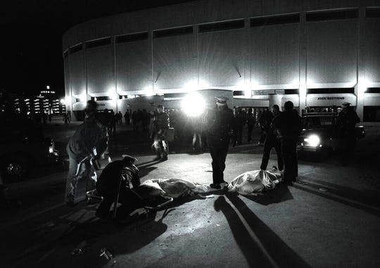 Dec. 3, 1979: Cincinnati police officers help people crushed during a performance by the rock group The Who at Riverfront Coliseum in Cincinnati. Eleven fans of the rock band were killed when a thousands-strong crowd stampeded to get into the concert.