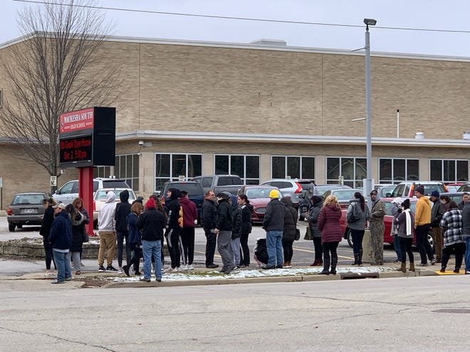 Parents gather outside Waukesha South High School moments before the school began releasing students at 11:15 a.m. Monday.