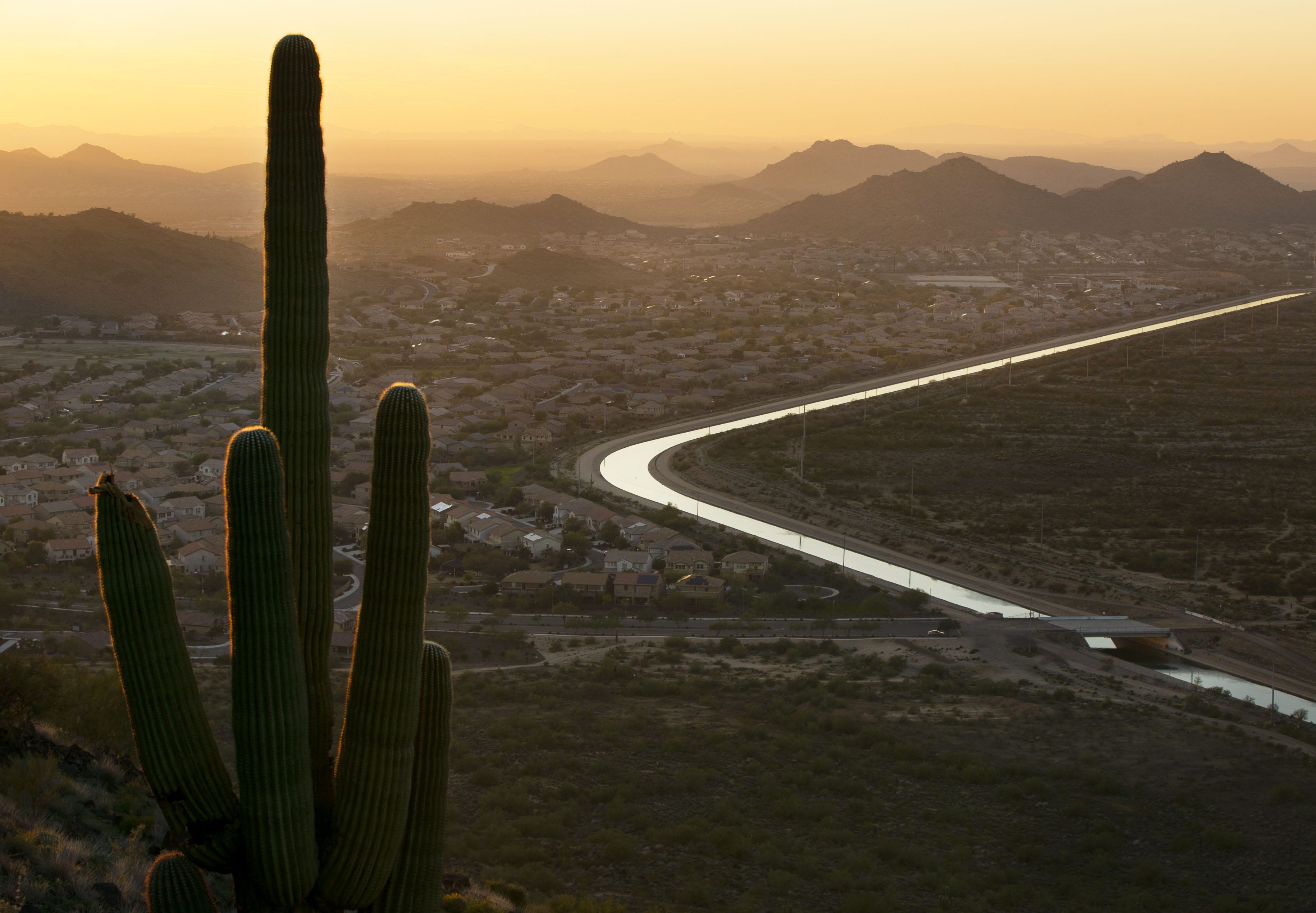 The Central Arizona Project Canal winds past a neighborhood in Phoenix carrying Colorado River water.