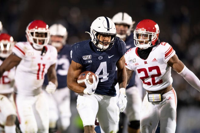 Penn State running back Journey Brown (4) eludes Rutgers defensive back Damon Hayes (22) in the second half of an NCAA college football game in State College, Pa., on Saturday, Nov. 30, 2019. (AP Photo/Barry Reeger)