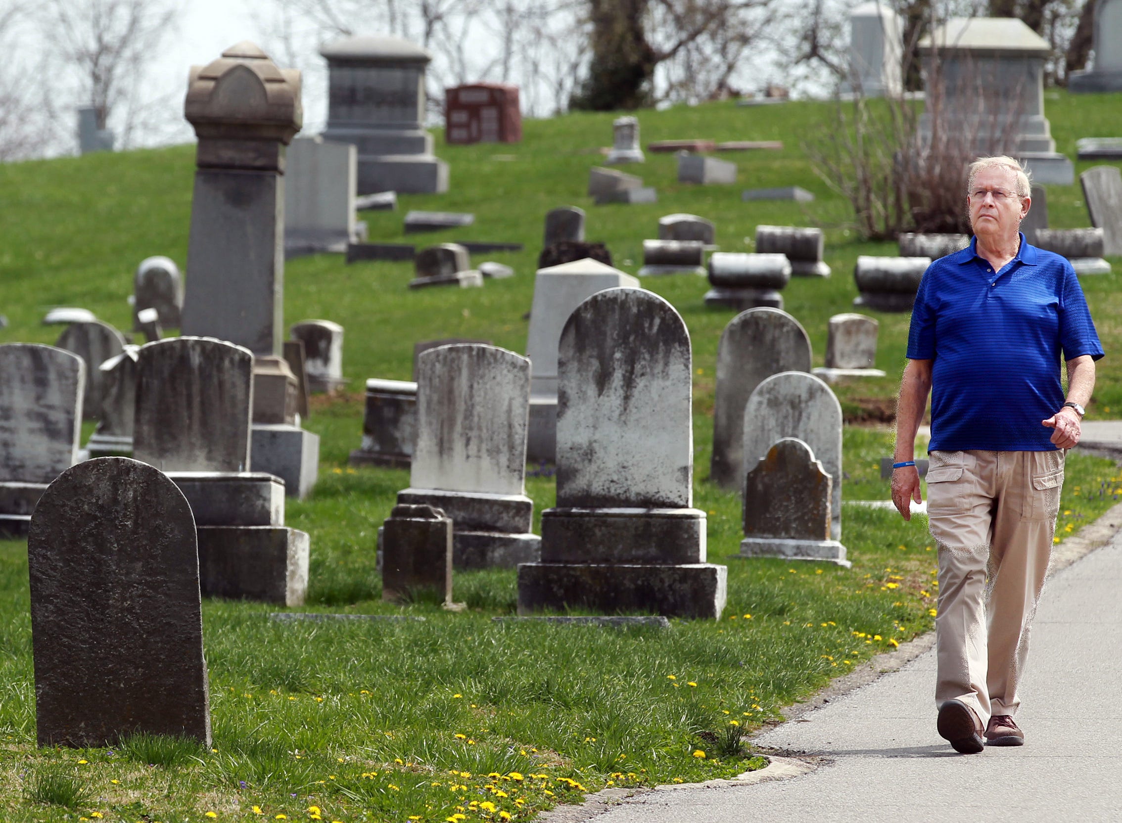 Noel Stegner of Fort Thomas walks in Evergreen Cemetery in Southgate where his grandson, Nicholas Specht, was buried after he died from an overdose in 2013. This was Stegner's first trip back to the cemetery.
