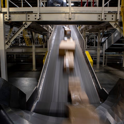 Packages move along a conveyor belt Wednesday, Dec