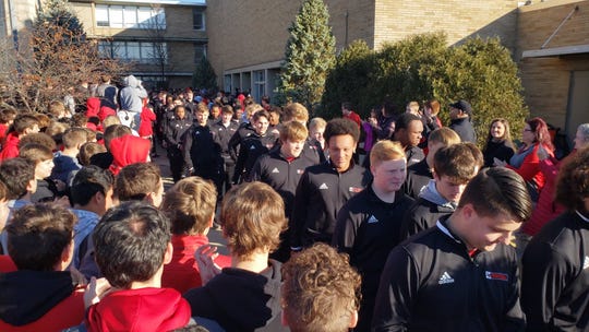 La Salle football team members enjoy an enthusiastic sendoff from students, faculty and fans as they head to Canton for the Division II state final with Massillon Washington.