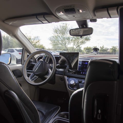 A passenger takes a ride in a Waymo self-driving c