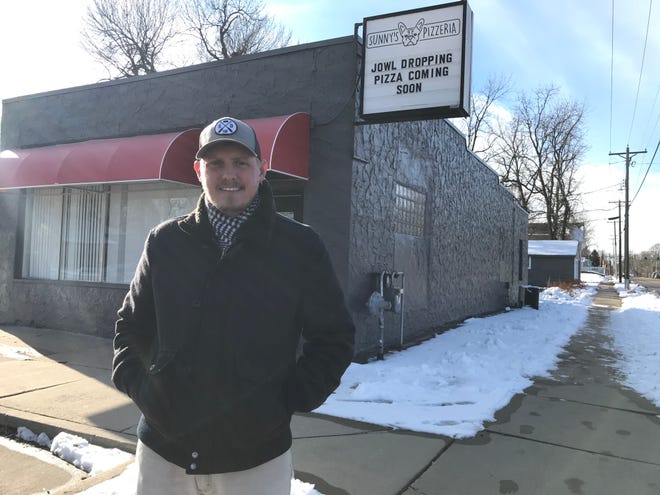 Sunny's Pizzaria owner Jon Oppold stand for a portrait outside his business, set to open Dec. 16.