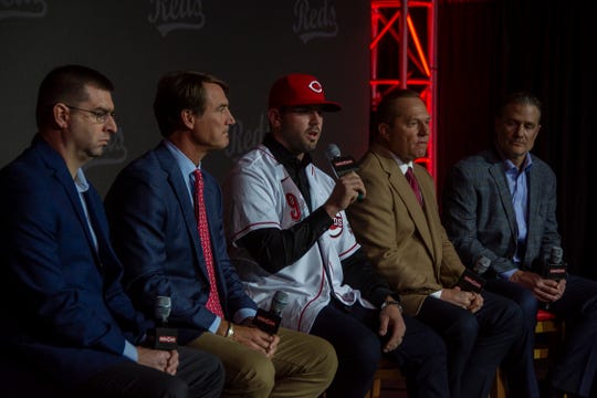 Cincinnati Reds infielder Mike Moustakas, center, addresses the media at his introductory press conference on Dec. 5, 2019 at the Duke Energy Convention Center. From left, Reds general manager Nick Krall, president of baseball operations Dick Williams, Moustakas, agent Scott Boras, and manager David Bell