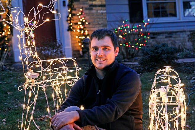 Mike Walczak sits outside his Wauwatosa home on Thursday, Dec. 5. For the last three years, Walczak has set up his outdoor holiday lights display to be controlled via a website. Anyone can use it.