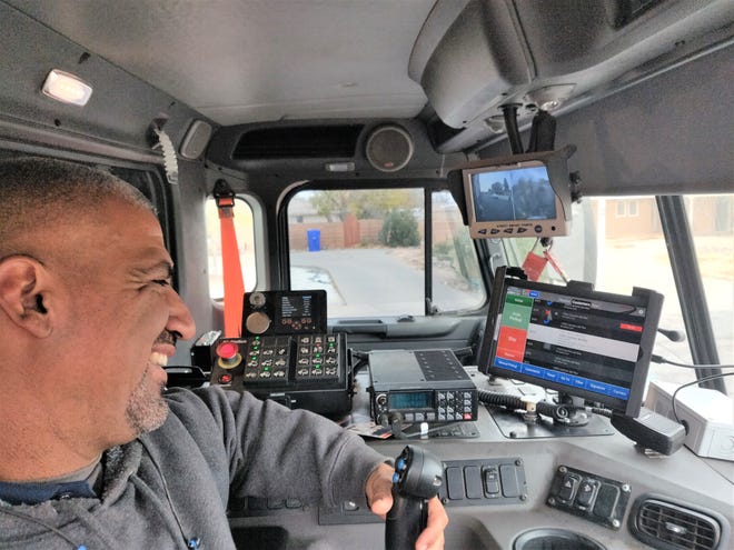 Heavy Equipment Operator Sergio Saenz checks his route through the Routeware tablet installed in the cab of his solid waste truck. The new smart technology documents every stop, allowing better and more efficient service to Las Cruces Utilities customers.
