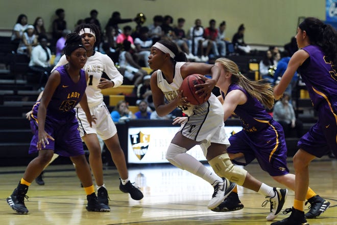 Treasure Coast High School's Brianna Houston makes her way to the basket through the Fort Pierce Central High School defense on Thursday. Dec. 5, 2019, during a District 9-7A game in Port St. Lucie. Treasure Coast won 71-24.