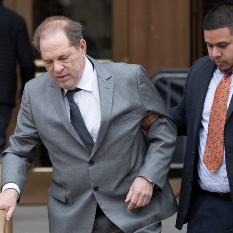 Harvey Weinstein, center, leaves court following a
