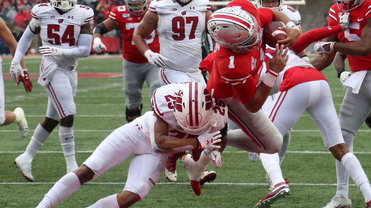Ohio State quarterback Justin Fields dives past Wisconsin safety Eric Burrell (25) for a touchdown during the third quarter of their game in 2019 at Ohio Stadium.