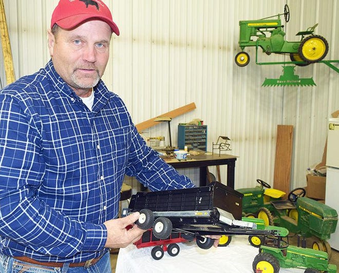 Dave Melland shows some of the intricate details of the feed wagon.