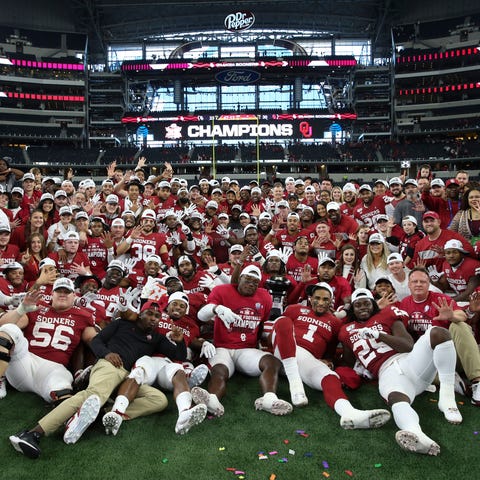 Oklahoma players and coaches take a team photo aft