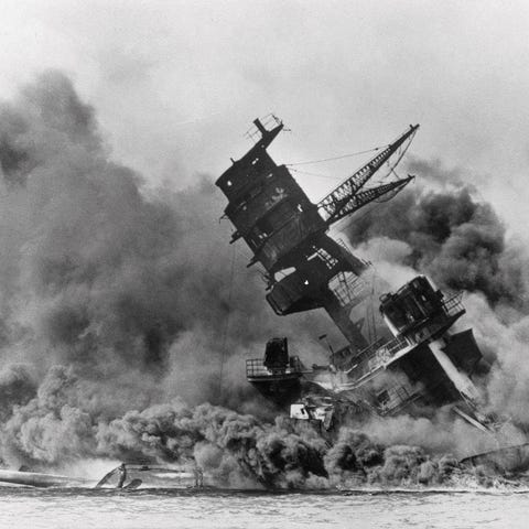 Smoke rises from the battleship USS Arizona as it 
