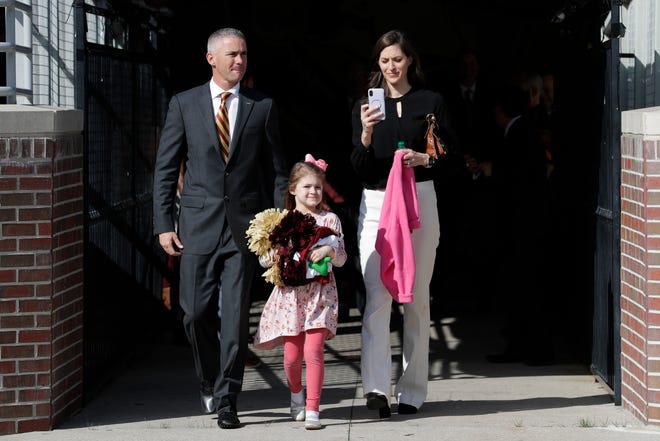 Newly hired Florida State University Head Football Coach Mike Norvell, his wife Maria Norvell and their daughter Mila Norvell, 5, walk across Bobby Bowden Field at Doak Campbell Stadium on their way to a press conference in the Champions Club where Mike Norvell will be introduced to the public Sunday, Dec. 8, 2019. 