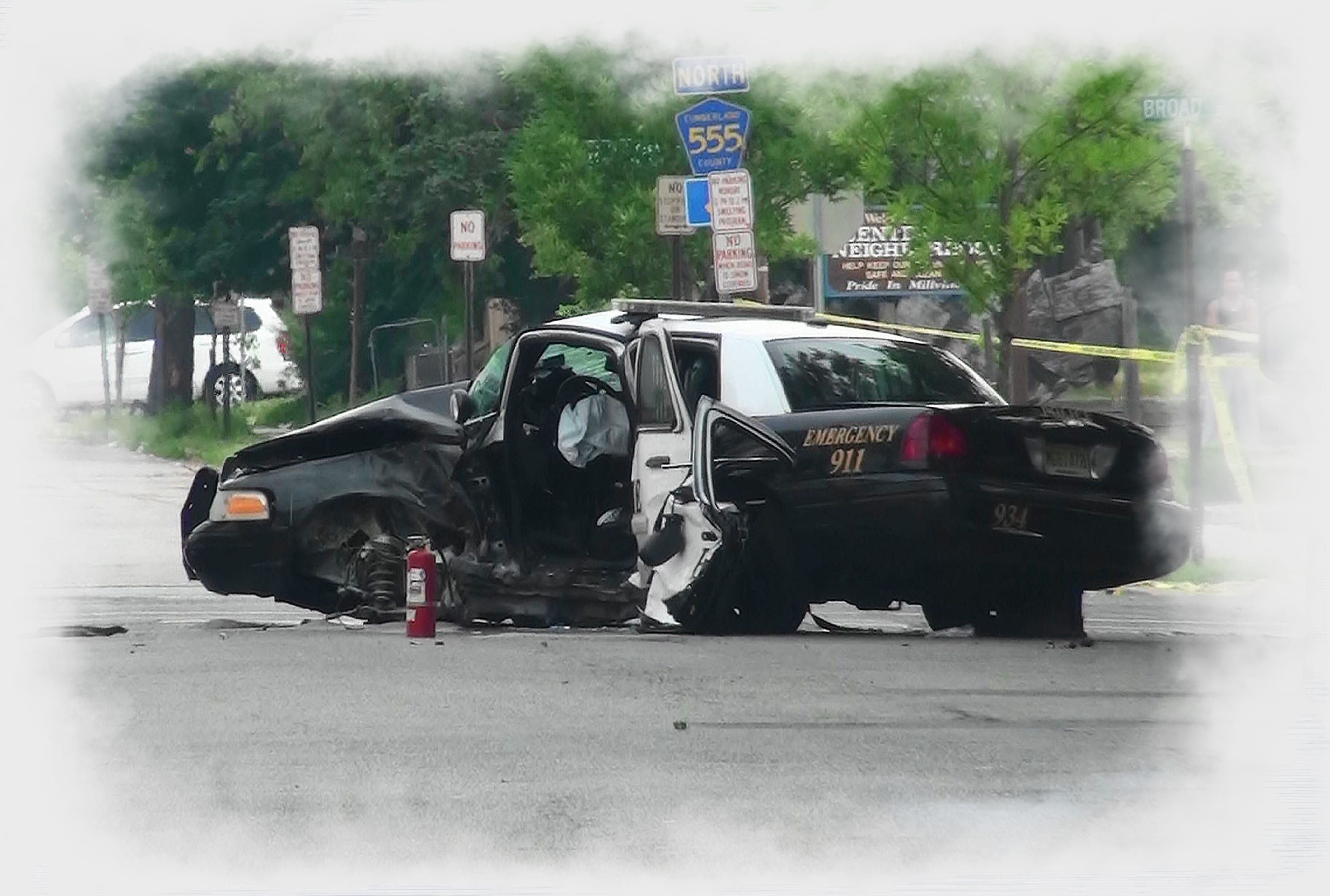 A heavily damaged Millville police cruiser rests near Broad and 3rd streets on Sunday morning, hours after a crash in which Officer Christopher Reeves was killed while on duty. Another officer in the car was seriously injured. Photo/Drew Eskridge Police cruiser crash in which Millville police officer Christopher Reeves was killed.