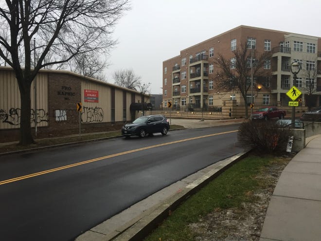 An affordable apartment development planned for a North Water Street site would replace a vacant industrial building. It's near several high-end housing developments, including Riverbridge Condominiums (right).