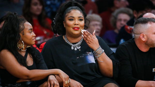 Singer Lizzo attends an NBA basketball game betwee
