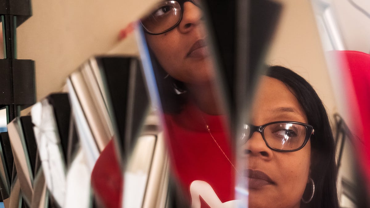 Nyosha Fowler of Detroit is seen posing in a mirror at her in home salon on Monday, September 30, 2019. Fowler had a botched Brazilian Butt Lift in Florida three years ago by surgeon Osakatukei Omulepu, who cut her intestine and hit her sciatic nerve during the process. She was in a coma for 28 days. She was on dialysis. Then she was in a wheelchair for a year, then leg braces. She's had four blood transfusions and eight surgeries since the Brazilian   Butt Lift. 