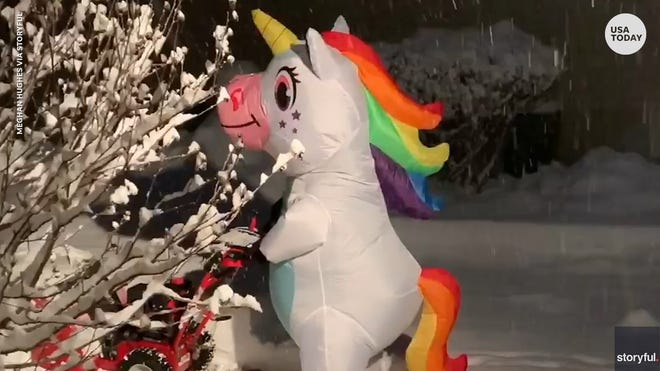 Rainbow unicorn makes shoveling snow look fun