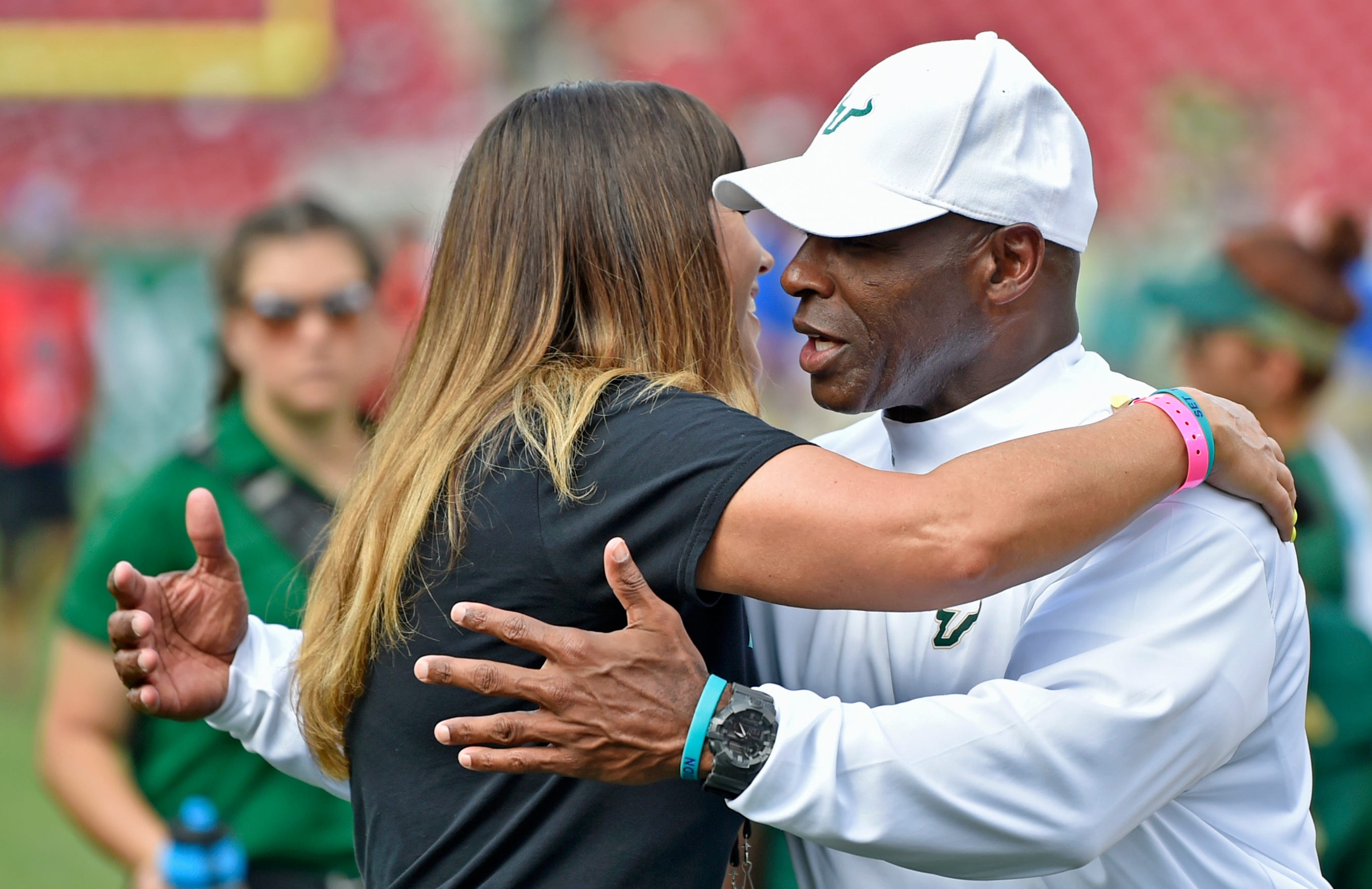 Brenda Tracy gives a pre-game hug to University of South Florida head coach football Charlie Strong on Sept. 28, 2019, in Tampa, Florida.