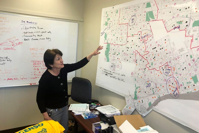 In this Nov. 22 photo, Detroit 2020 Census Campaign executive director Victoria Kovari looks over a Detroit map showing city neighborhoods that were under-counted in the 2010 census.