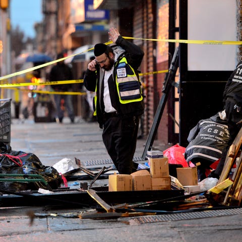 A clean up crew sifts through the debris at the Je