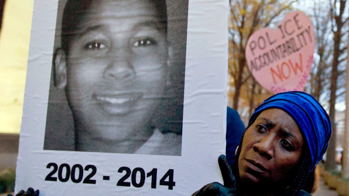 Tomiko Shine holds up a picture of Tamir Rice during a protest in Washington, D.C. Rice was fatally shot by a rookie police officer in Cleveland on Nov. 22, 2014. The 12-year-old was holding a toy gun while playing in the park when he was shot and killed.