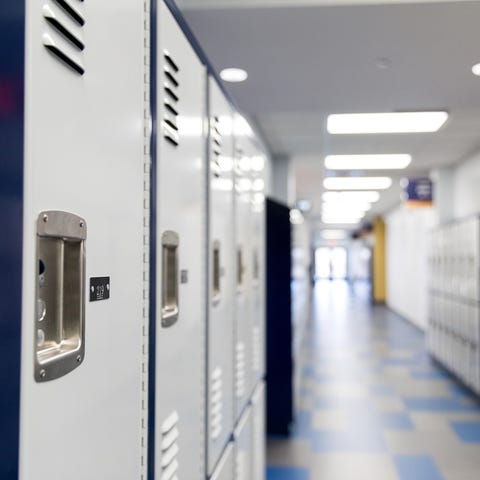 Lockers line empty hallway in school building.