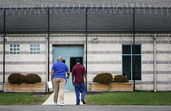 A staff member escorts a youthful offender at the Circleville Juvenile Correctional Facility south of Columbus in Pickaway County.