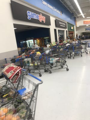 Abandoned carts fill Walmart just after 4 p.m. Thursday, Dec. 12, 2019, soon after authorities cleared the building of any danger. Police responded at about 12:30 p.m. to reports of a "loud pop" followed by a man fleeing.
