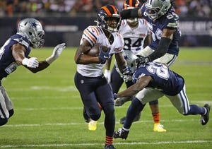 Anthony Miller #17 of the Chicago Bears runs between Chidobe Awuzie #24 (left) and Darian Thompson #23 of the Dallas Cowboys on hos way to a touchdown at Soldier Field on Dec. 05, 2019, in Chicago. The Bears defeated the Cowboys 31-24.