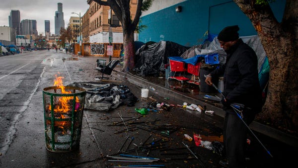 A homeless man made a fire from trash to keep warm