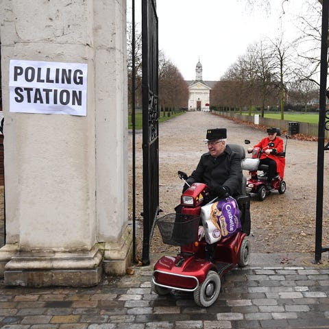 Retirees arrive to cast their vote at a polling, o