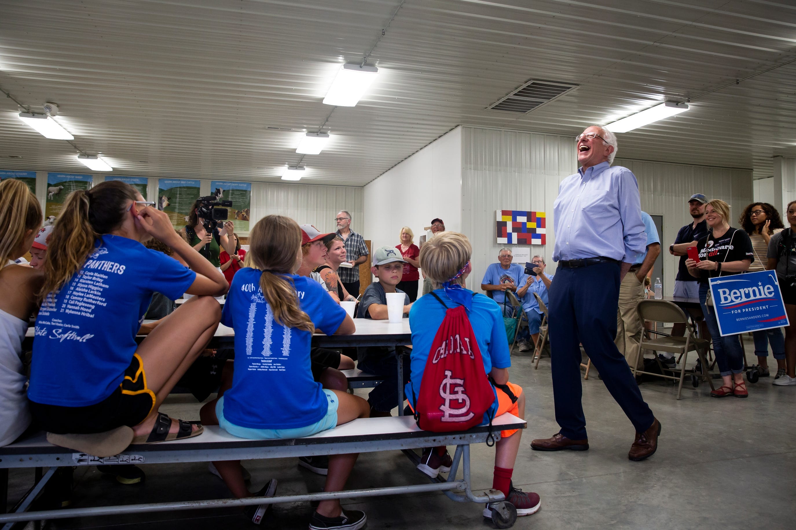 Vermont Senator and 2020 Democratic presidential candidate Bernie Sanders laughs at a response as he talks to kids at the Union County Democrats booth during the Union County fair on Saturday, July 20, 2019, in Afton. 
